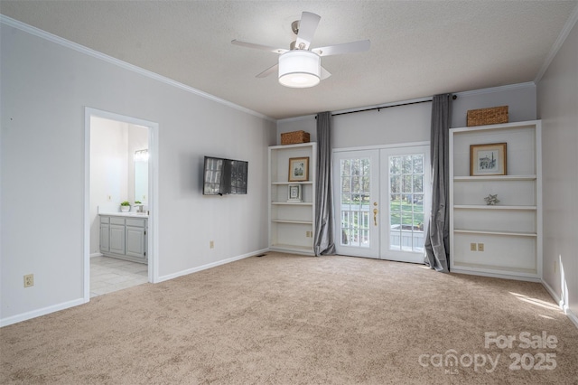 spare room featuring a textured ceiling, a ceiling fan, carpet flooring, and crown molding