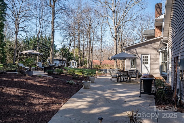 view of patio featuring outdoor dining area and grilling area