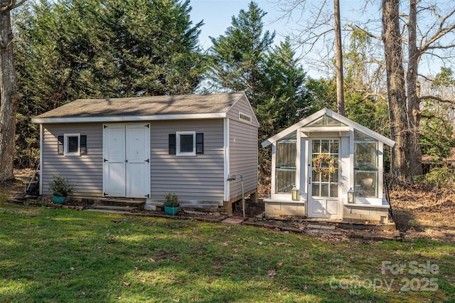 view of greenhouse featuring entry steps and a yard