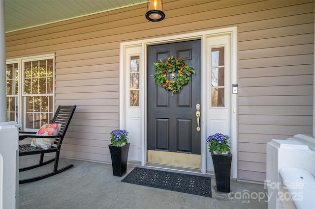 view of exterior entry with a porch