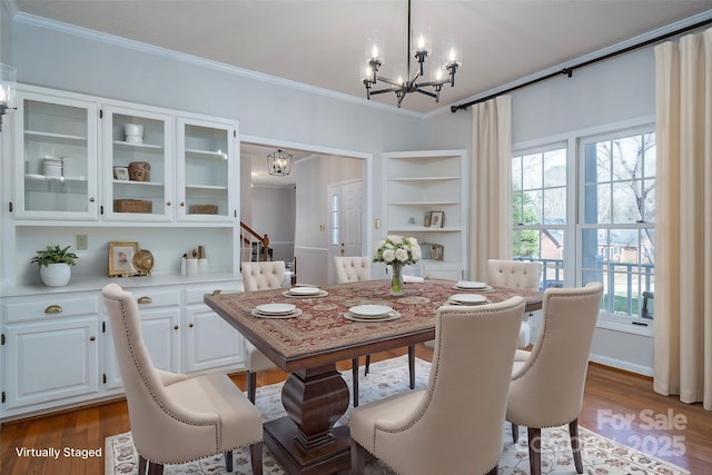107 Doris Ct, Lincolnton, NC 28092 - dining room with a chandelier, ornamental molding, wood finished floors, built in features, and stairway