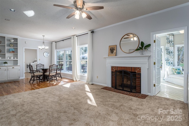 107 Doris Ct, Lincolnton, NC 28092 - living room featuring carpet, a textured ceiling, ornamental molding, a brick fireplace, and ceiling fan