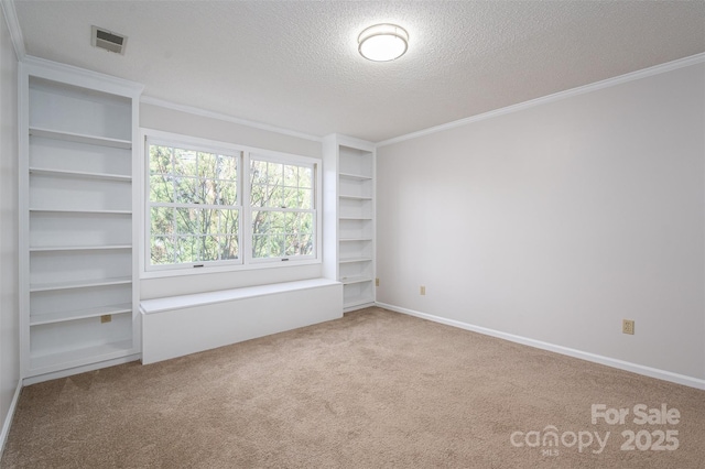 107 Doris Ct, Lincolnton, NC 28092 - spare room with a textured ceiling, carpet, crown molding, baseboards, and built in shelves