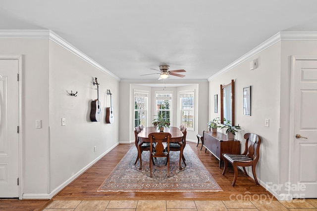 dining space featuring ornamental molding and light wood-style floors