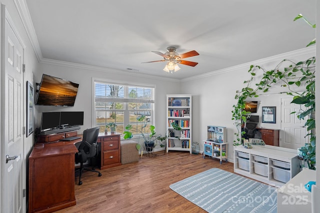 office space featuring ceiling fan, wood finished floors, visible vents, and crown molding