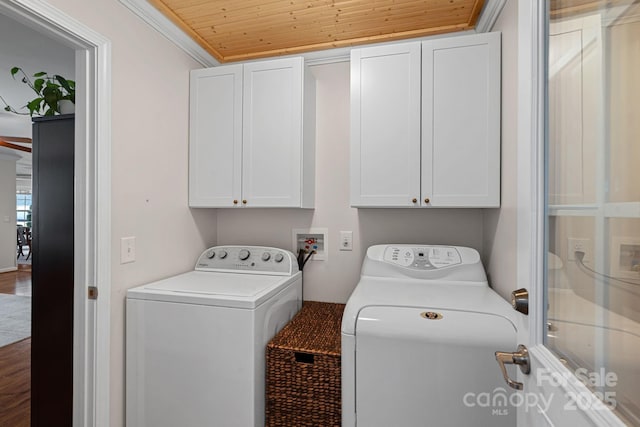 laundry area with wood ceiling, separate washer and dryer, cabinet space, and crown molding