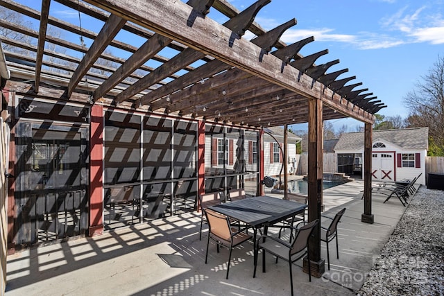 view of patio / terrace with an outbuilding, outdoor dining area, a fenced in pool, a pergola, and a shed