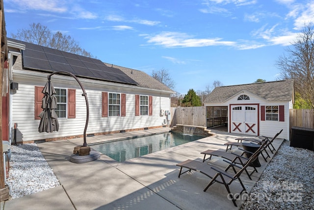 view of pool with a fenced in pool, an outbuilding, a patio area, and a fenced backyard