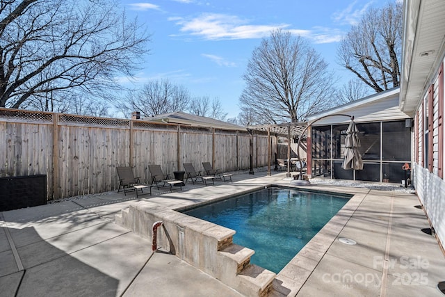 view of swimming pool with a fenced in pool, a sunroom, a patio area, and a fenced backyard