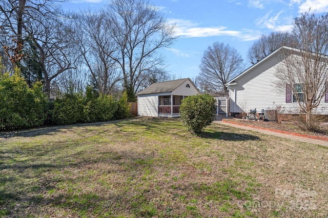 view of yard featuring an outbuilding and fence