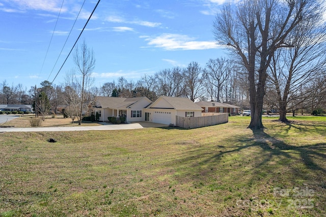 view of front facade featuring a front yard, concrete driveway, and an attached garage