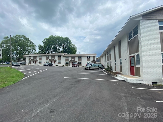 uncovered parking lot with a residential view