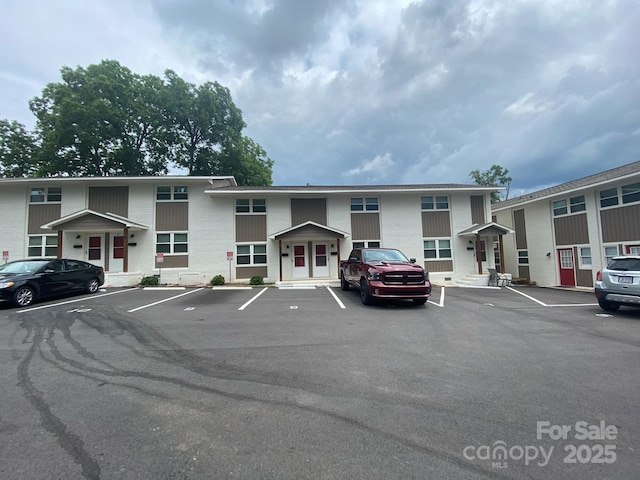 view of building exterior featuring uncovered parking