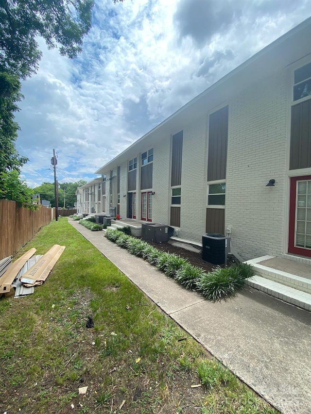 view of community with fence and a lawn