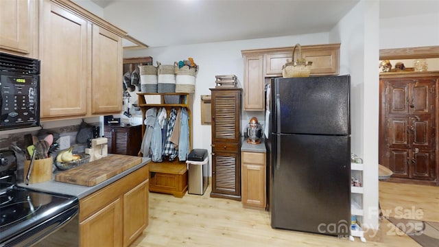 kitchen featuring black appliances and light wood-style floors