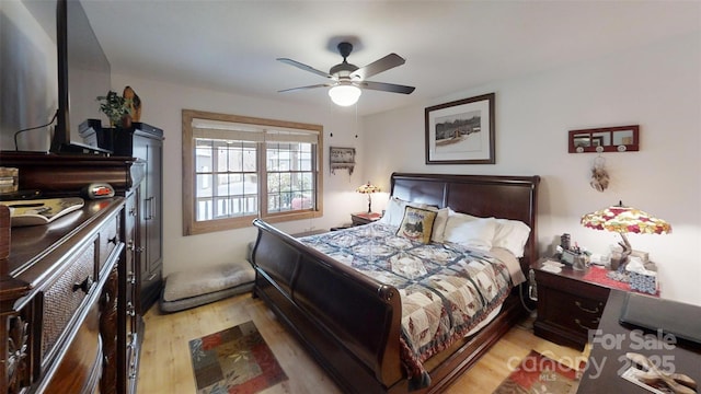 bedroom with light wood-style flooring and a ceiling fan