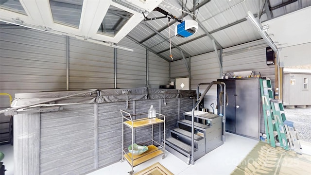 interior space with metal wall and a garage door opener