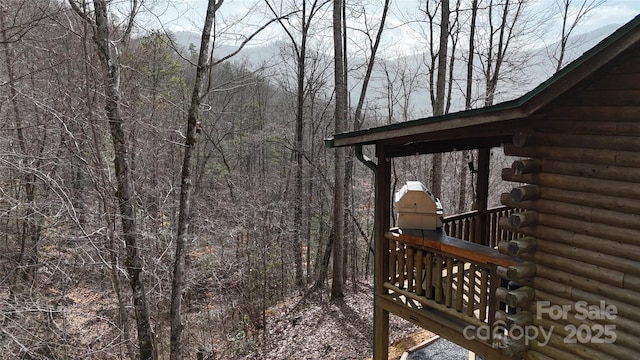 wooden terrace with a wooded view