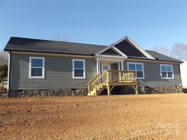 view of front of house featuring a shingled roof and crawl space