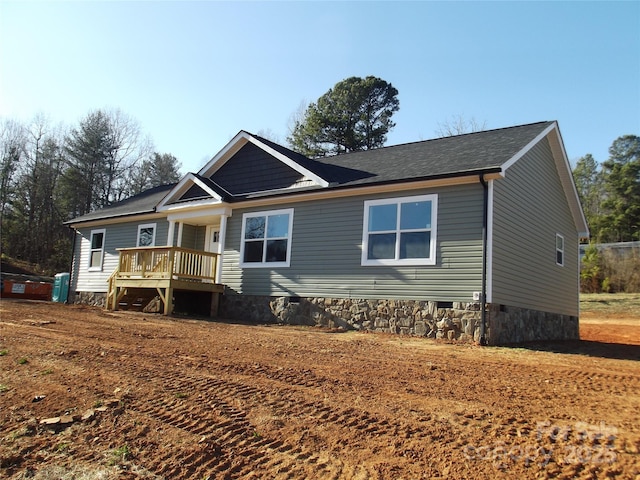 view of front of home with a deck and crawl space