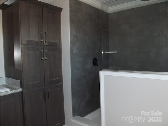 bathroom with walk in shower and crown molding