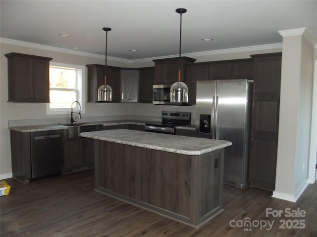 kitchen featuring a kitchen island, a sink, appliances with stainless steel finishes, dark wood-style floors, and crown molding