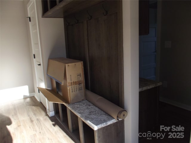 mudroom featuring baseboards and light wood finished floors