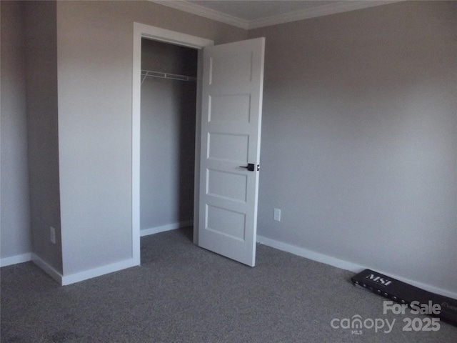 unfurnished bedroom featuring carpet floors, baseboards, a closet, and ornamental molding