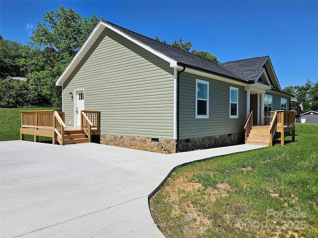 784 Severt Cir NE, Lenoir, NC 28645 - view of home's exterior featuring crawl space, a deck, a shingled roof, and a yard