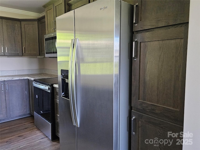 784 Severt Cir NE, Lenoir, NC 28645 - kitchen featuring appliances with stainless steel finishes, crown molding, dark wood-type flooring, light countertops, and dark brown cabinetry