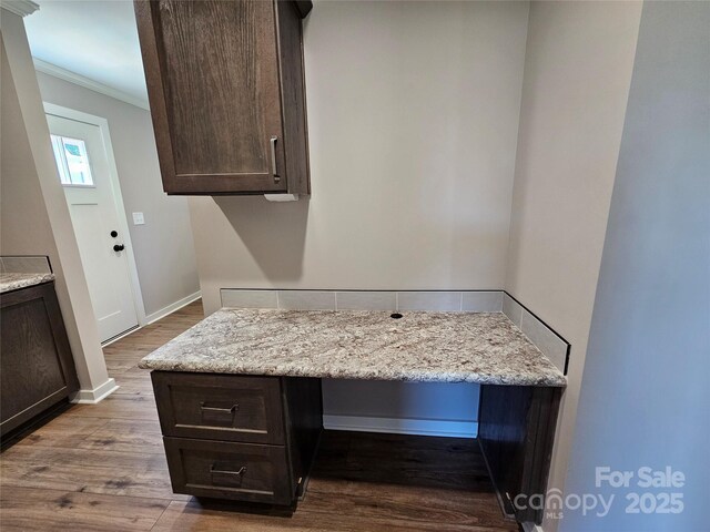 784 Severt Cir NE, Lenoir, NC 28645 - kitchen featuring dark brown cabinetry, crown molding, wood finished floors, light stone counters, and baseboards
