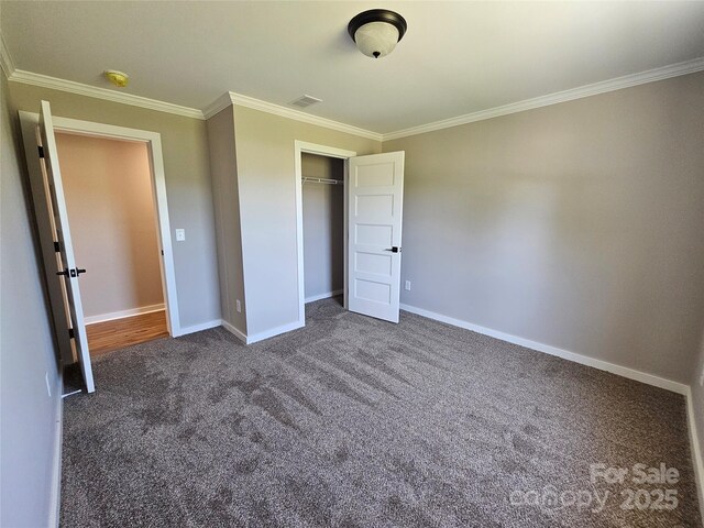 784 Severt Cir NE, Lenoir, NC 28645 - unfurnished bedroom featuring crown molding, dark colored carpet, baseboards, and a closet
