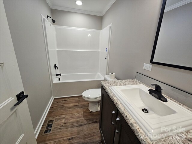784 Severt Cir NE, Lenoir, NC 28645 - bathroom with ornamental molding, toilet, wood finished floors, vanity, and washtub / shower combination