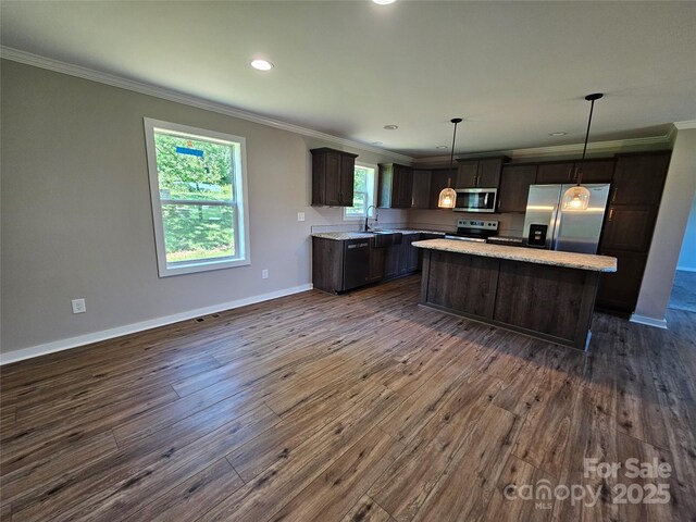 784 Severt Cir NE, Lenoir, NC 28645 - kitchen featuring stainless steel appliances, crown molding, dark wood finished floors, dark brown cabinets, and a kitchen island