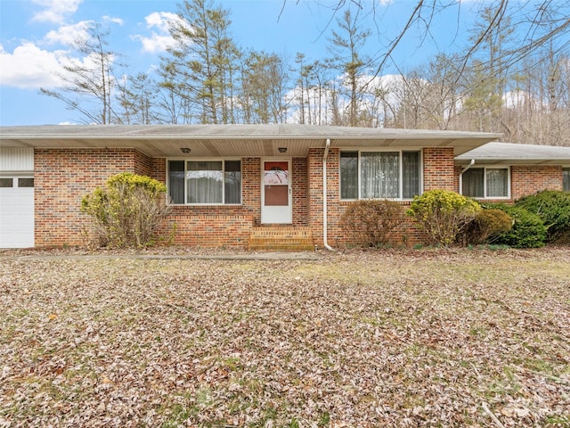 ranch-style home with brick siding and an attached garage