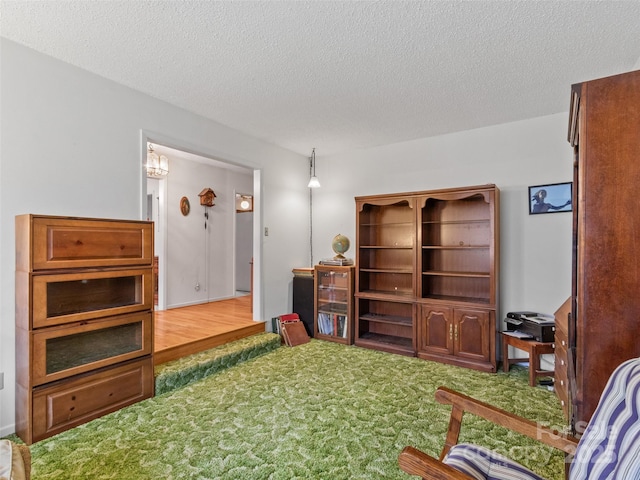 sitting room with carpet flooring and a textured ceiling