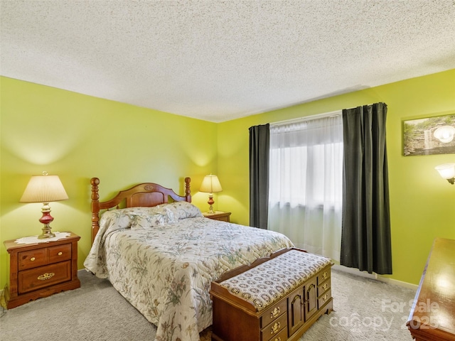 bedroom featuring light carpet and a textured ceiling