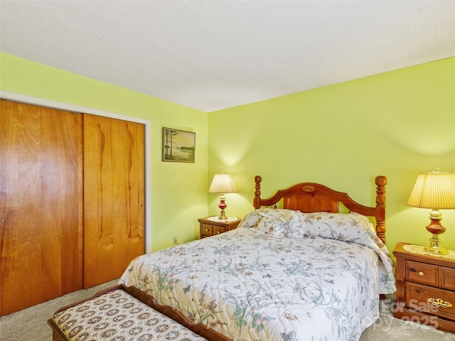 carpeted bedroom with a closet and a textured ceiling