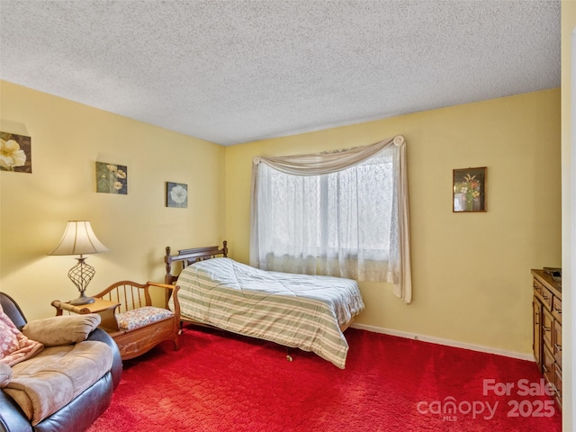 carpeted bedroom with a textured ceiling and baseboards