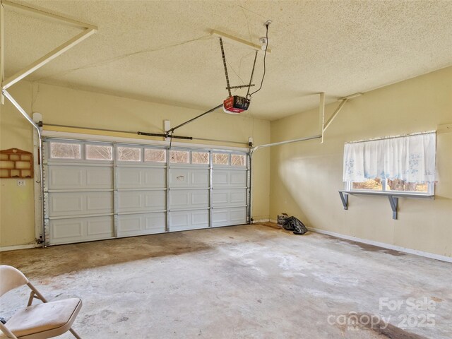 garage featuring baseboards and a garage door opener