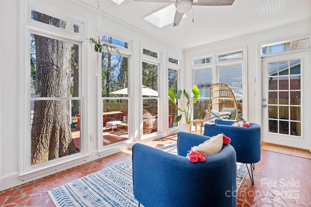 sunroom featuring a skylight and a ceiling fan