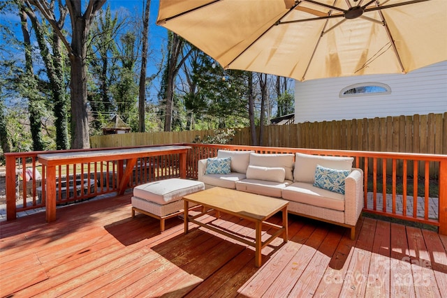 wooden terrace featuring fence and outdoor lounge area