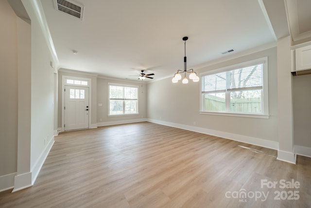 unfurnished living room with crown molding, visible vents, and light wood finished floors