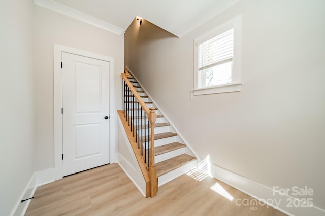 stairs with baseboards and wood finished floors