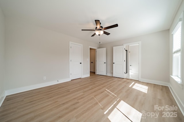 unfurnished bedroom with light wood finished floors, baseboards, and ceiling fan