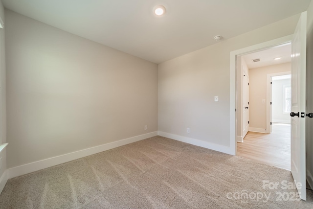 unfurnished room with light colored carpet, baseboards, and recessed lighting