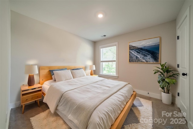 bedroom with baseboards and visible vents
