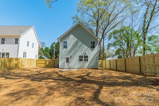 back of property with a fenced backyard
