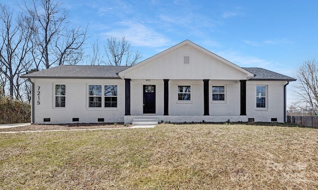 view of front of property featuring a front yard, crawl space, and brick siding