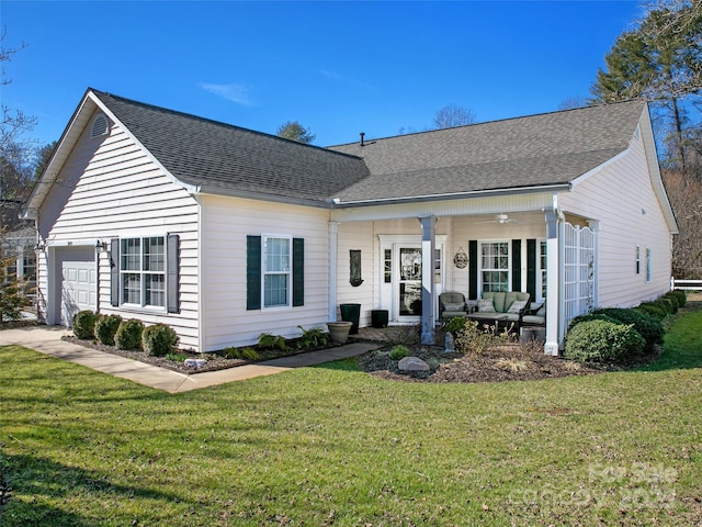 view of front of home with a garage, a shingled roof, a ceiling fan, an outdoor living space, and a front yard